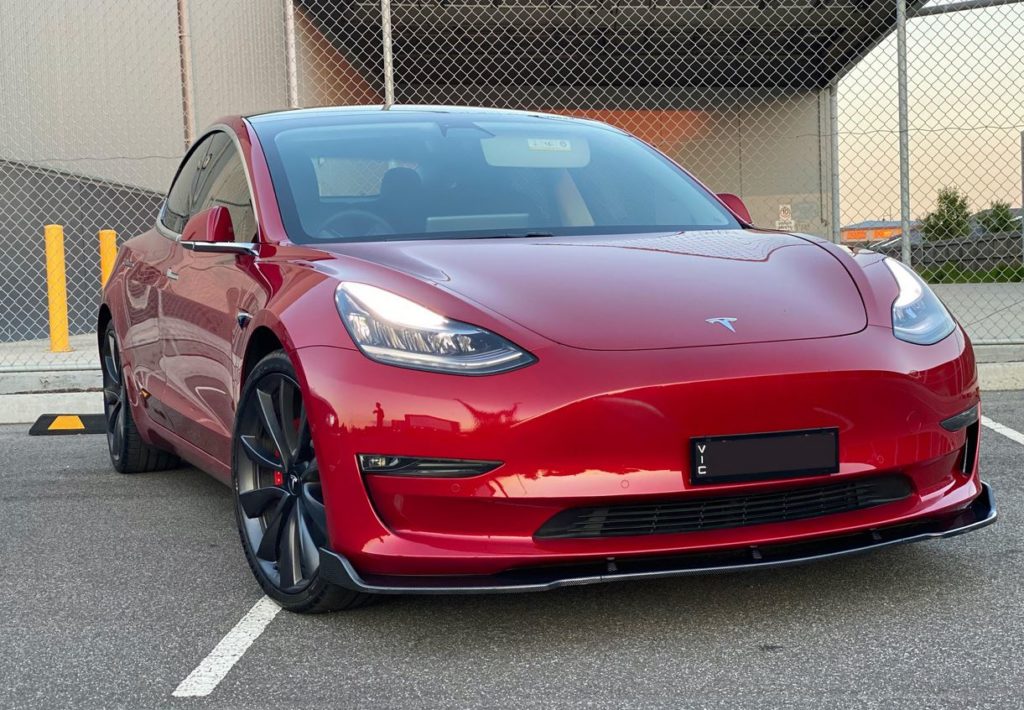 Red Tesla model 3 with carbon fiber front lip Tesla Model 3 Wiki