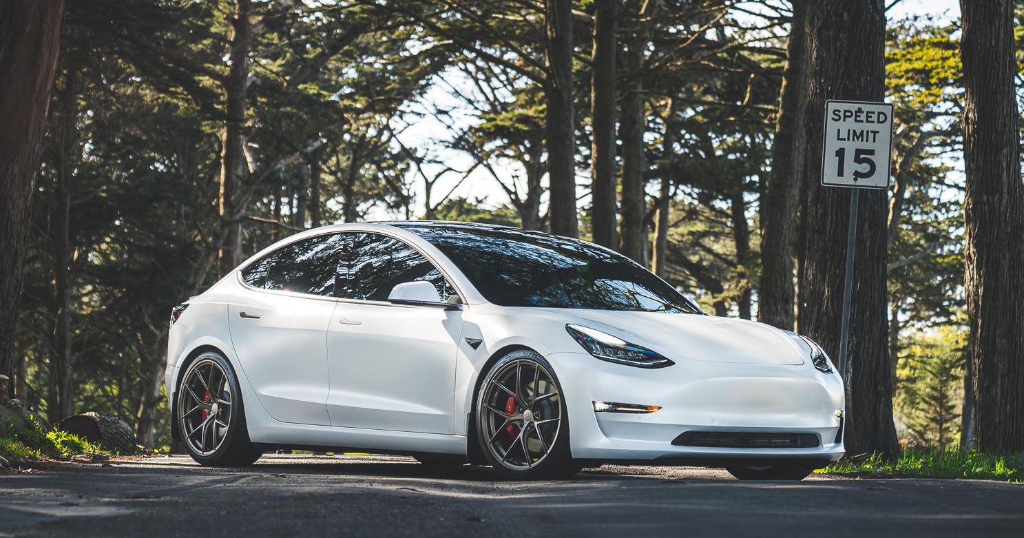 white tesla model 3 lowered with staggered titan 7 wheels